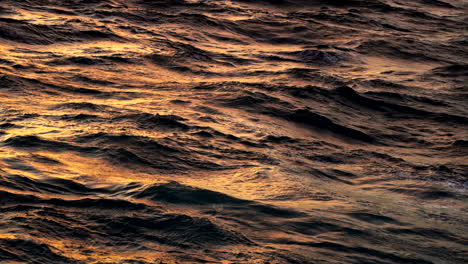 Unseen-golden-hour-sky-illuminates-surface-of-Indonesian-Ocean-water