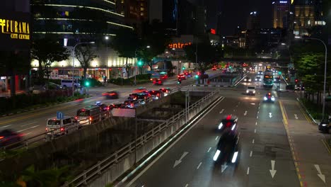 Night-timelapse-shot-capturing-busy-vehicle-traffic-motions-on-New-bridge-road-and-Eu-Tong-Sen-Street-at-downtown-Singapore