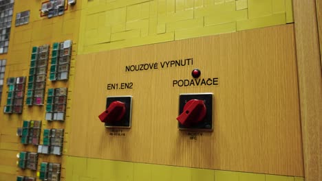 Indoor-power-plant-control-room-with-button-panel-on-wall-with-writings