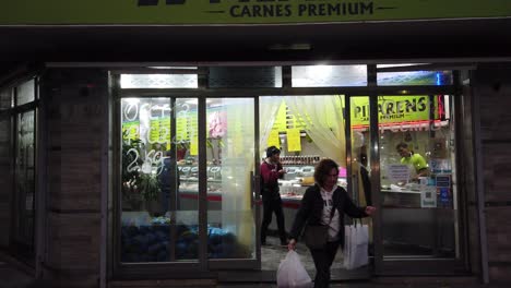 Argentine-people-buy-meat-at-nighttime-in-city-store,-famous-nutrition-buenos-aires-city,-south-american-country,-commercial-exchange