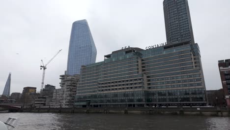 Sailing-Past-Sea-Containers-House-On-The-South-Bank-In-London-With-One-Blackfriars-Tower-Building-In-Background
