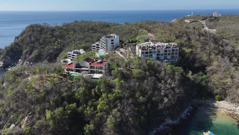 Houses,-hotels,-and-residences-nestled-in-the-mountains-surrounding-the-bays-of-Huatulco,-Oaxaca,-Mexico