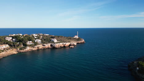 Aerial-view-of-Porto-Colom-lighthouse-and-coastline,-Mallorca