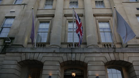 The-Gainsborough-Bath-Spa-Facade-With-Waving-Flags-In-Bath,-England,-United-Kingdom