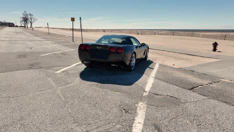 A-lovely-corvette-taking-in-the-beach-views-in-Muskegon,-MI-at-Pere-Marquette