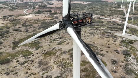 Aerial-medium-closeup-view-of-a-wind-turbine-destroyed-by-a-fire-in-a-mountainous-area-in-SE-Spain