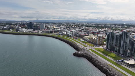 Drone-Shot-of-Reykjavik,-Iceland,-Coastal-Traffic,-Modern-Residential-Buildings-on-Waterfront