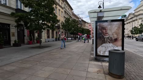 Walking-through-the-streets-of-Warsaw,-Poland,-amid-pedestrian-zones-next-to-traffic-of-buses-and-cars,-captures-the-essence-of-travel-and-exploration