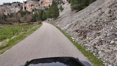 Driver-POV-immersive-view-with-the-front-of-a-black-4x4-in-sight,-driving-along-a-narrow-mountain-road