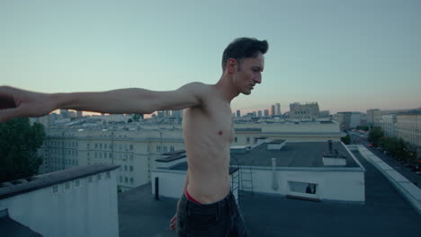 Shirtless-Man-Walking-on-The-Edge-of-Tall-Building,-Sunset,-Lonely,-Slow-Motion