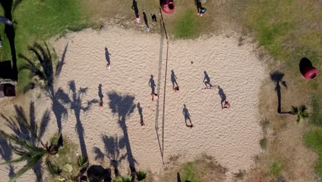 Top-View-of-Group-of-People-Playing-Beach-Volleyball,-Holidays-Activities