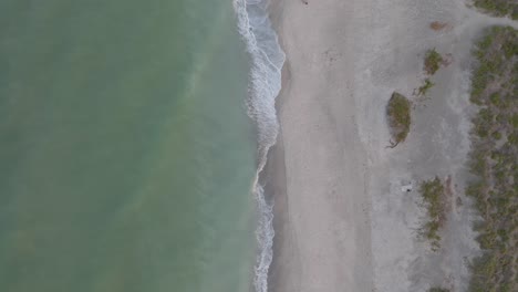 Looking-down-on-the-waves-crashing-at-Turtle-Beach,-Florida