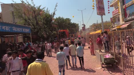 pov-shot-A-lot-of-men-are-walking-towards-the-temple-where-a-lot-of-people-are-flying-colors-and-a-lot-of-people-are-looking-at-him