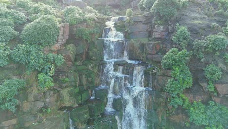 Aerial-drone-footage-of-a-tall-rocky-waterfall-in-the-Yorkshire-Dales,-Pennies