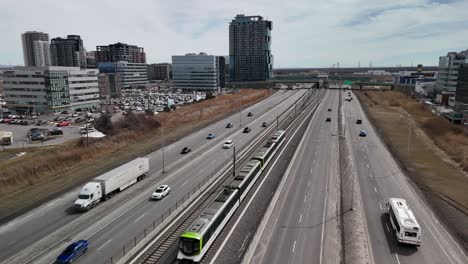 The-Réseau-express-métropolitain-REM-automated-light-rail-system-in-Brossard,-near-Montreal-city,-green-alternative-to-car-traffic-pollution-in-main-modern-metropolitan-city