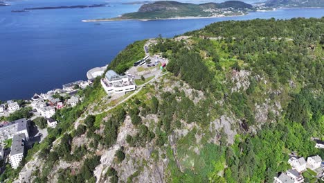 Aerial-View-of-Observation-Deck-Building-Above-Alesund-Town-and-Norwegian-Sea,-Drone-Shot-60fps