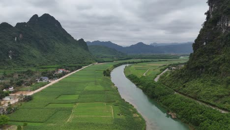 Aerial-Drone-Shot-of-River-Passing-Through-The-Village-In-Vietnam