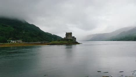 Low-Aerial-Reveal-of-Eilean-Donan-Castle-on-Loch-Duich-in-the-Highlands-Of-Scotland---Scottish-Landscape