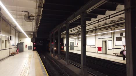 Inside-vintage-acoyte-station-in-south-american-subway-white-tiles-train-arriving-underground-wagons,-people-wait-inside,-buenos-aires-argentina-transportation