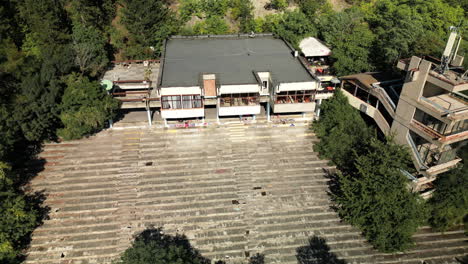 Close-up-Aerial-view-of-Abandoned-Entertainment-Post-Communist-Building-near-Sofia,-by-the-Pancherevo-Lake