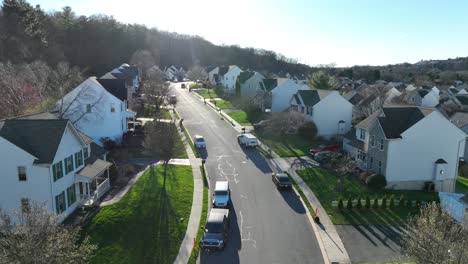 Aerial-birds-eye-of-american-suburb-homes-on-hill-during-sunny-day-in-spring