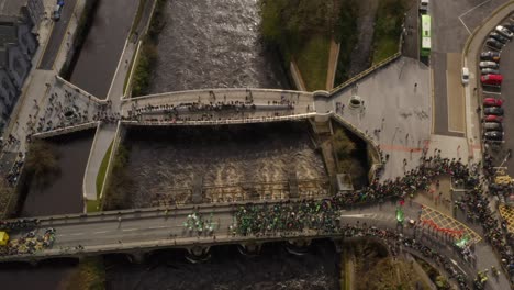 Drone-bird's-eye-view-above-families-gathered-to-watch-parade-in-Galway-Ireland