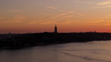 Silhouette-of-National-Sanctuary-of-Christ-the-King-on-Tagus-River-at-sunset