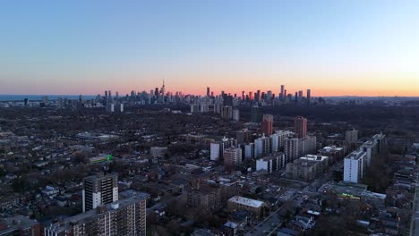 This-4k-drone-video-shows-the-drone-flying-over-an-East-York-neighbourhood-toward-downtown-Toronto-at-sunset