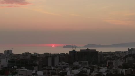 Golden-Horizon-Over-Pacific-Ocean-from-Miraflores,-Lima,-Peru---Aerial-Dolly-In