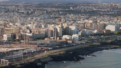 Cargo-train-passing-on-the-sea-side-at-the-city-of-Catania-in-Italia