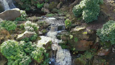 Aerial-drone-footage-of-a-tall-rocky-waterfall-in-the-Yorkshire-Dales,-Pennies