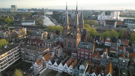 Drone-Flies-Past-Posthoornkerk-Church-Bell-Towers-in-Amsterdam,-Netherlands