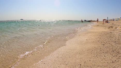 Waves-Splashing-On-Sandy-Shore-Of-Beach-In-Marsa-Alam,-Egypt---High-Angle-Shot