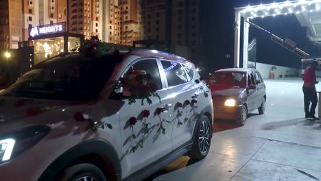 The-scene-shows-a-classic-wedding-car-adorned-with-fresh-flowers-for-the-bride-and-groom's-special-day