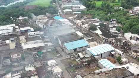 aerial-drone-view-drone-camera-is-moving-towards-the-right-side-different-factories-are-visible-and-piles-of-food-are-also-visible-and-a-river-is-also-visible-next-to-the-factories