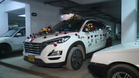 An-image-showcasing-a-classic-groom-car-adorned-with-fresh-flower-arrangements-for-a-wedding-ceremony