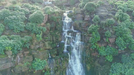 Aerial-drone-footage-of-a-tall-rocky-waterfall-in-the-Yorkshire-Dales,-Pennies