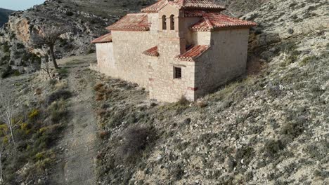 Aerial-drone-shot-flying-backward-of-an-isolated-Hermitage-in-an-arid-Landcape