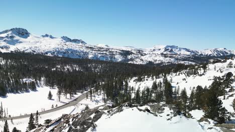 Aerial-view-of-Carson-Pass-roadway,-mountains-and-forest,-Kirkwood,-California