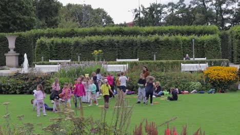 Children-joyfully-play-in-the-yard-of-the-Royal-Castle-in-Warsaw,-Poland,-embodying-the-concept-of-innocence-and-happiness-amidst-historical-splendor