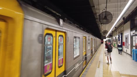 People-walk-inside-urban-vintage-subway-latin-american-station-line-A-buenos-aires-argentina,-first-underground-line-of-South-America