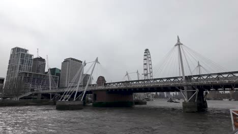 Sailing-Past-Hungerford-Bridge-and-Golden-Jubilee-Bridges-On-River-Thames