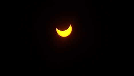 Time-lapsed-shot-of-the-partial-phase-of-a-solar-eclipse-moving-across-the-sky