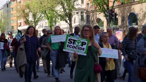 Climate-change-activists-marching-in-streets-of-Stockholm,-static-view