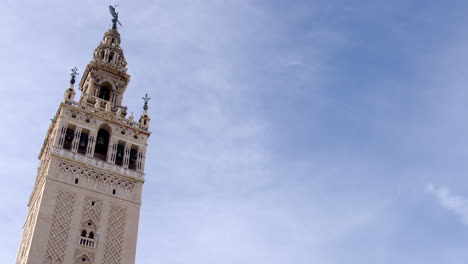 The-Giralda-bell-tower-of-Seville-Cathedral-in-Seville,-16th-century-belfry-at-the-top-of-the-Giralda-tower,-Spain