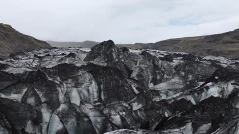 Drone-Shot-of-Solheimajokull-Glacier-and-Glacial-Lake-in-Landscape-of-Iceland