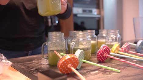 Young-latin-girl-prepare-cocktail-mocktail-or-smoothie-at-her-kitchen