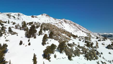 Aerial-ascent-of-Carson-Pass-lookout-of-snow-covered-mountains,-California