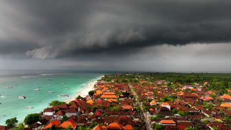 Incredible-color-contrast-between-stormy-black-clouds-over-turquoise-ocean-water-of-Nusa-Lembongan-in-Indonesia