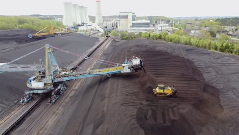 Chvaletice-Power-Station,-Chvaletice,-Czech-Republic---Managing-Coal-at-the-Power-Plant---Aerial-Pullback-Shot